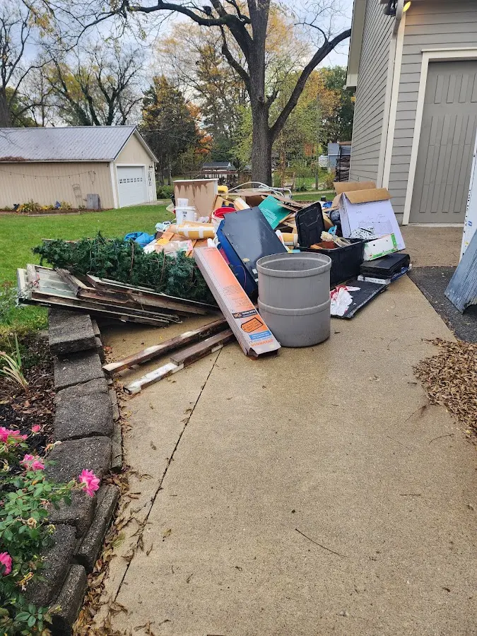 Dumpster being loaded with debris for 12 Yard Dumpster Rental in Forestdale
